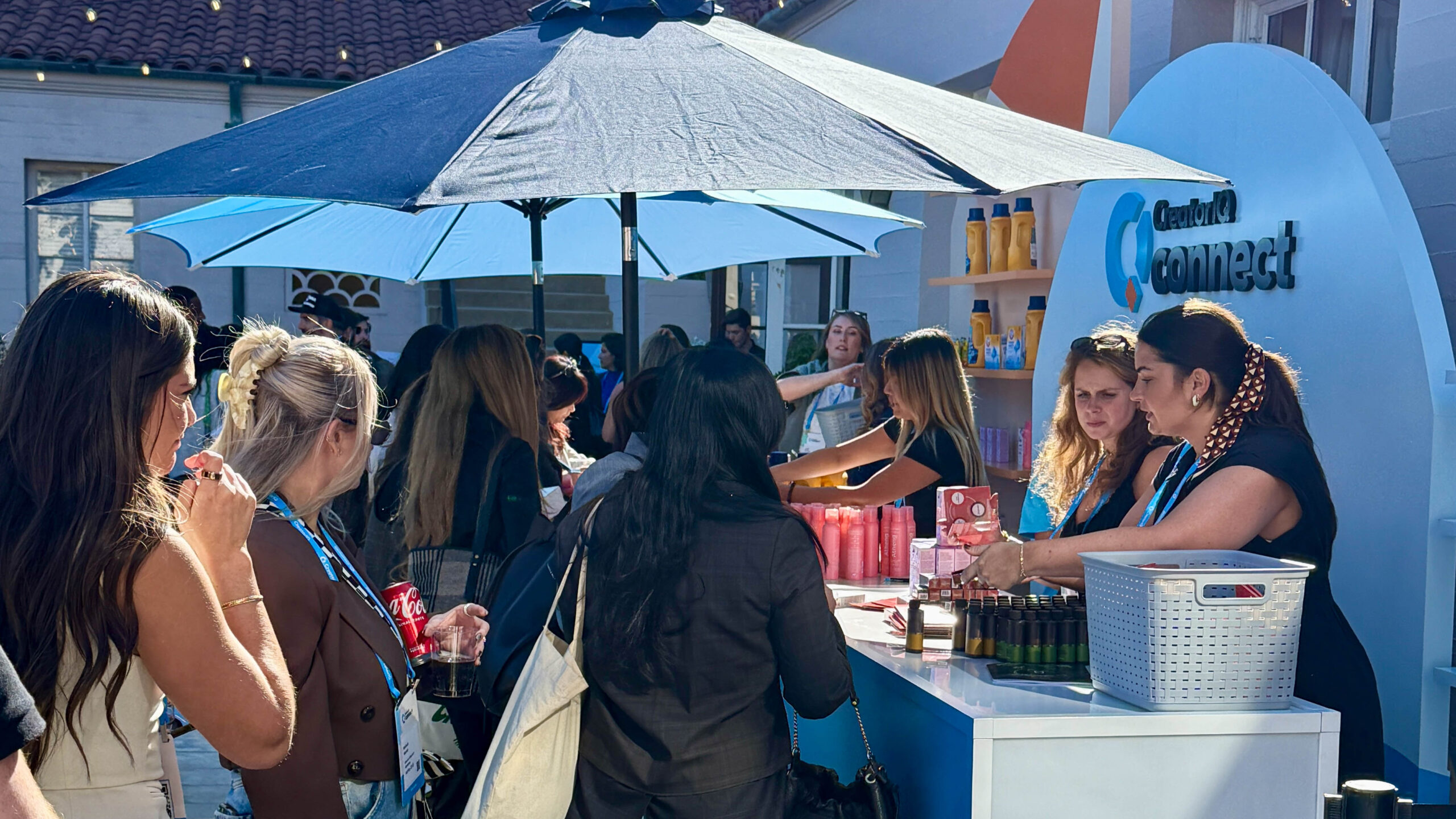 People handing out favors to guests in the outdoor part of the venue at CreatorIQ Connect.